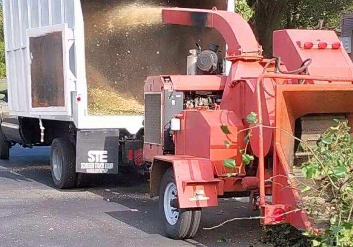 A machine disposing tree branches on a truck